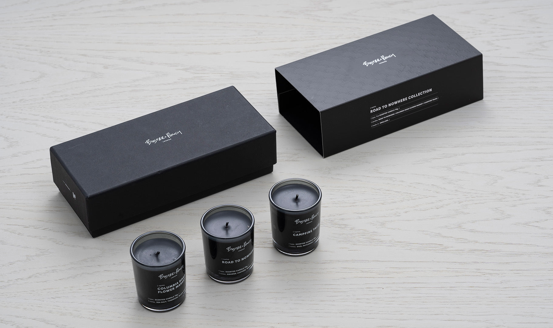 Æske indeholdende 3 duftlys af sort voks i røgfarvede glas